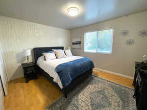 Bedroom featuring light wood-type flooring and baseboards