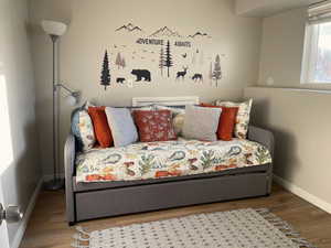 Bedroom with baseboards and wood finished floors