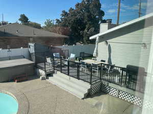 View of patio / terrace with a deck, a hot tub, and area for grilling