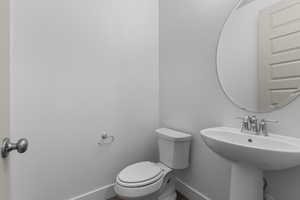 Bathroom featuring toilet and baseboards