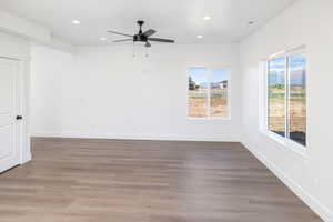 Empty room featuring dark wood-type flooring, recessed lighting, and ceiling fan