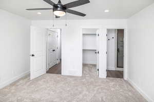 Unfurnished bedroom featuring recessed lighting, a spacious closet, light carpet, and ceiling fan