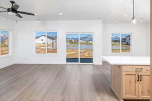 Unfurnished living room featuring light wood finished floors, recessed lighting, and a water view