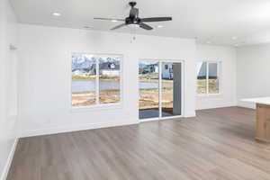 Unfurnished living room with light wood-type flooring, recessed lighting, and ceiling fan