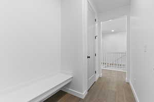 Mudroom featuring wood-type flooring and baseboards