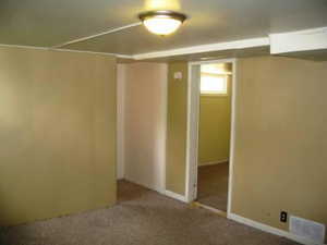 Below grade area featuring carpet flooring and baseboards
