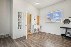Office area with built in features and wood finished floors
