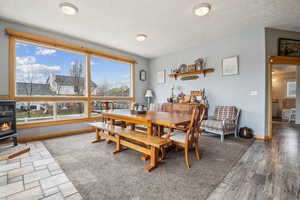 Dining room with a wood stove and baseboards