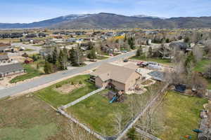 Aerial overview of property's location with a mountainous background and nearby suburban area