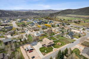 Aerial view of property's location with nearby suburban area and a mountain backdrop