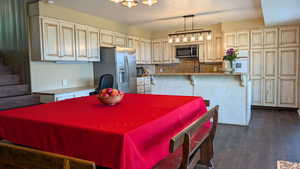 Dining room featuring dark wood finished floors and a textured ceiling