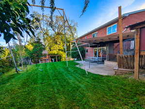 View of yard with a patio area and a playground