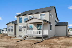 Back of property with a patio, stucco siding, and a wooden deck