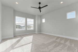 Unfurnished room featuring light colored carpet, recessed lighting, and a ceiling fan