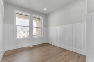 Spare room featuring wainscoting, light wood-type flooring, and recessed lighting
