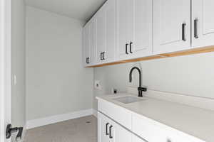 Laundry room with cabinet space, hookup for a washing machine, light carpet, and electric dryer hookup