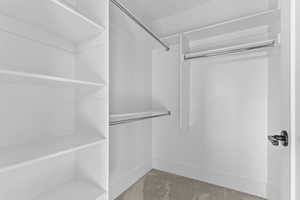 Spacious closet featuring carpet floors