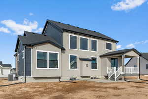 Back of property featuring a patio area and a shingled roof