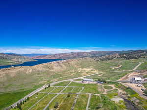 Aerial view of property and surrounding area featuring a water and mountain view