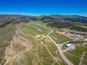 Aerial view of property and surrounding area featuring mountains