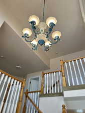 Stairs featuring a chandelier