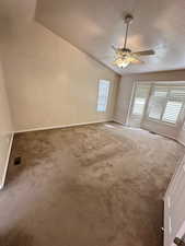 Spare room with carpet floors, a ceiling fan, and a textured ceiling