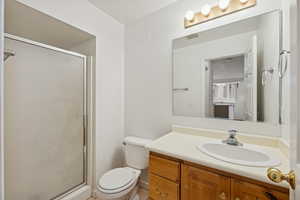 Bathroom featuring a shower stall and vanity