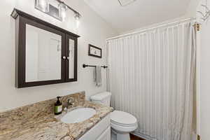 Full bath with vanity and curtained shower