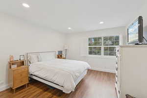 Bedroom featuring wood finished floors and recessed lighting