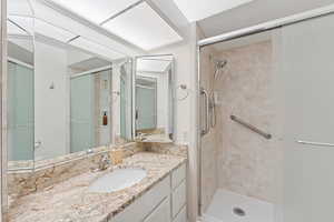 Bathroom featuring a stall shower and vanity