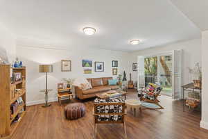 Living room with wood finished floors and baseboards