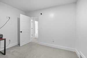 Unfurnished office with light carpet and baseboards