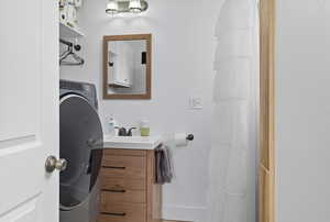 Bathroom featuring washer / dryer and vanity