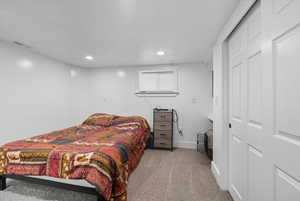 Bedroom with light colored carpet and recessed lighting