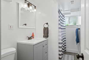 Bathroom with vanity and a shower with shower curtain