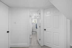 Corridor featuring baseboards and wood finish floors
