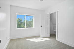 Unfurnished bedroom with light carpet and a textured ceiling