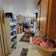 Dining room with lofted ceiling, a textured ceiling, and a chandelier