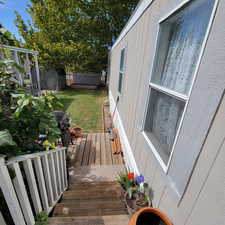Wooden deck with a fenced backyard
