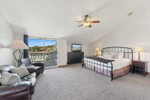 Bedroom featuring access to exterior, carpet, a ceiling fan, lofted ceiling, and a textured ceiling