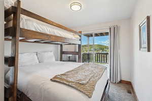 Bedroom with access to outside and carpet floors
