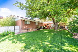 Back of property featuring brick siding, a deck, and crawl space