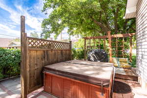 Wooden deck featuring a hot tub and grilling area