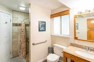 Full bathroom featuring vanity, a stall shower, and tile patterned floors