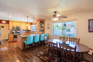 Dining space with dark wood-type flooring and recessed lighting
