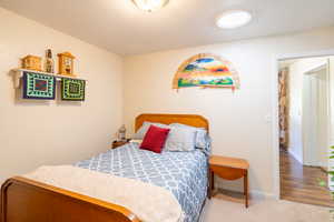 Carpeted bedroom featuring baseboards