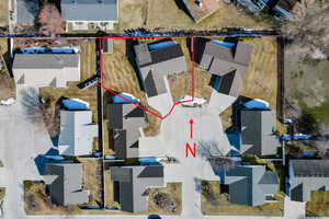 Aerial view of residential area featuring property boundaries highlighted