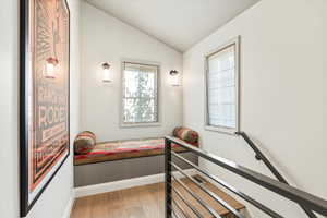 Bedroom featuring vaulted ceiling and light wood-style floors