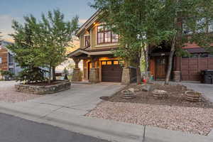View of front facade featuring concrete driveway and a garage