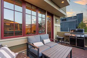 View of patio with a grill and a deck